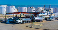 Fuel tanker trucks at refinery fueling station, CA