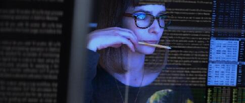 woman analyzing data on computer screen