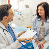 male doctor speaking with female patient